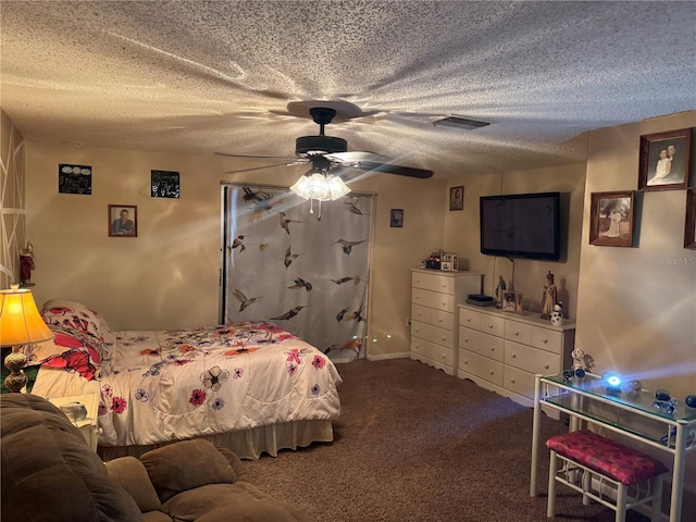 carpeted bedroom with a textured ceiling and ceiling fan