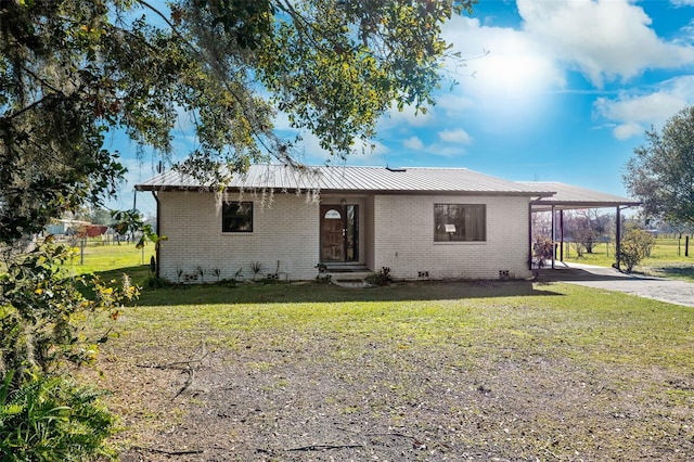 single story home featuring a carport and a front lawn