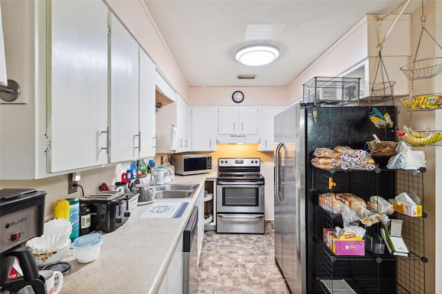 kitchen featuring sink, white cabinets, and appliances with stainless steel finishes