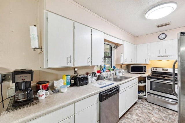 kitchen featuring appliances with stainless steel finishes, sink, and white cabinets