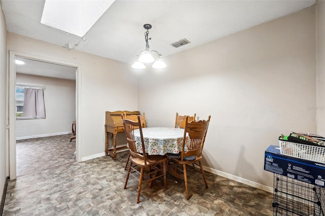 dining space with a skylight