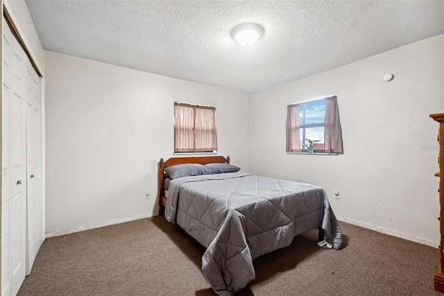 bedroom with carpet floors and a textured ceiling