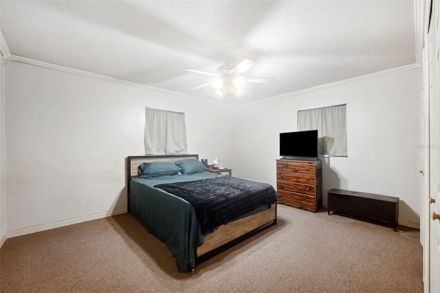 carpeted bedroom featuring crown molding and ceiling fan