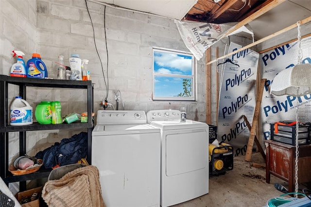 clothes washing area with separate washer and dryer