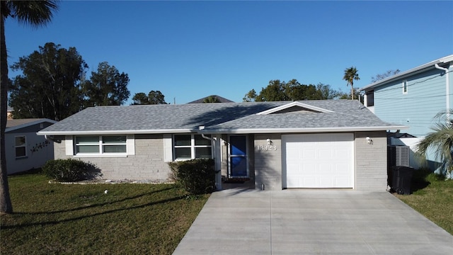 single story home featuring a garage and a front yard