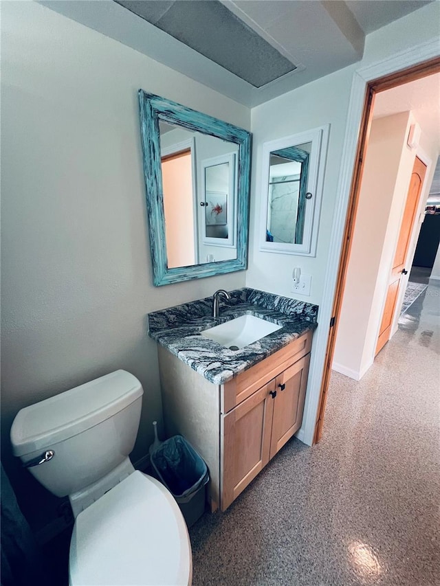 bathroom featuring vanity and toilet