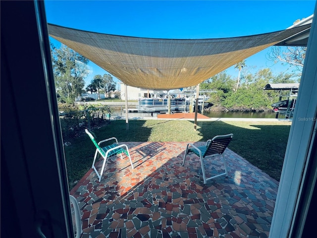 view of patio / terrace with a water view and a dock