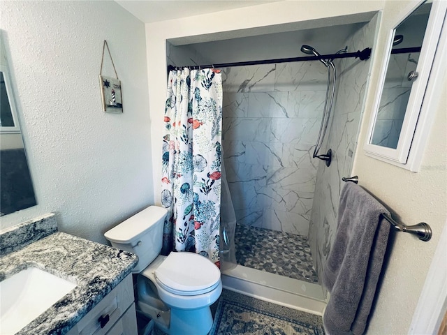 bathroom featuring a shower with curtain, vanity, and toilet