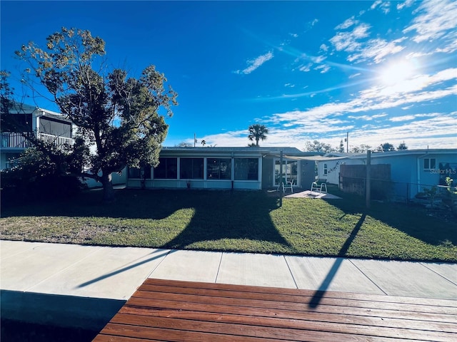 back of house featuring a sunroom and a yard