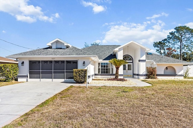 single story home featuring a garage and a front yard