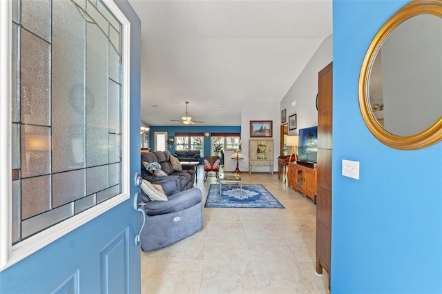 tiled living room featuring vaulted ceiling and ceiling fan