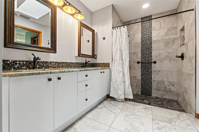 bathroom featuring walk in shower and vanity