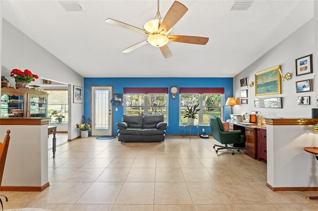 office space with ceiling fan, lofted ceiling, a textured ceiling, and light tile patterned floors