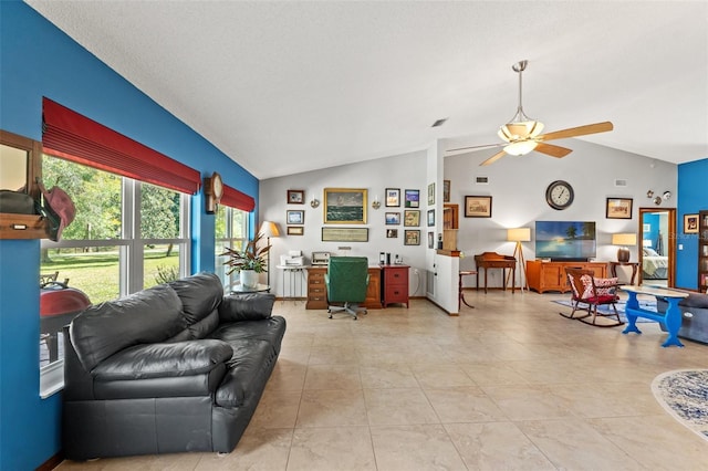 living room with light tile patterned floors, vaulted ceiling, and ceiling fan