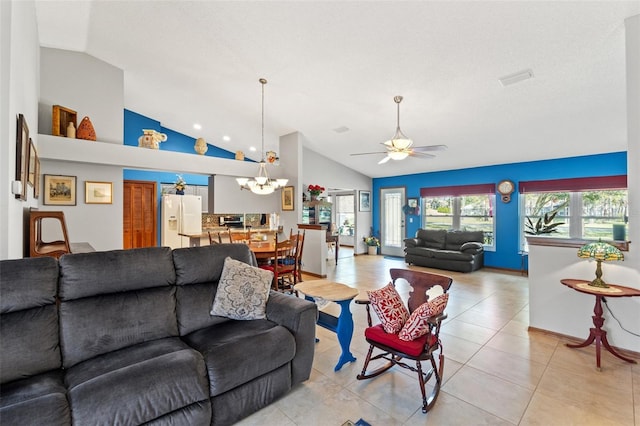 tiled living room featuring ceiling fan with notable chandelier and vaulted ceiling