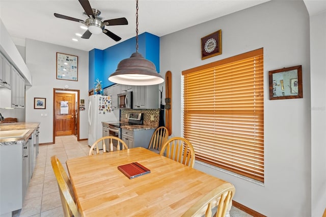 dining room featuring light tile patterned floors, sink, and ceiling fan