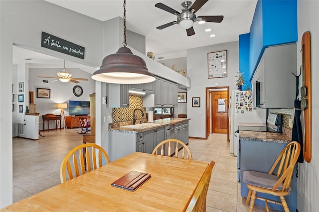 tiled dining area with sink and ceiling fan