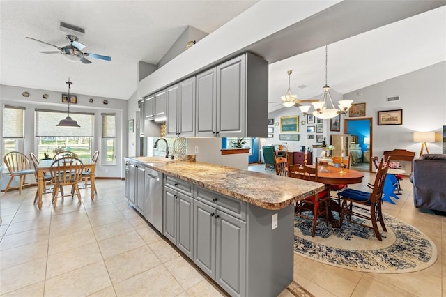 kitchen with pendant lighting, sink, vaulted ceiling, and gray cabinetry