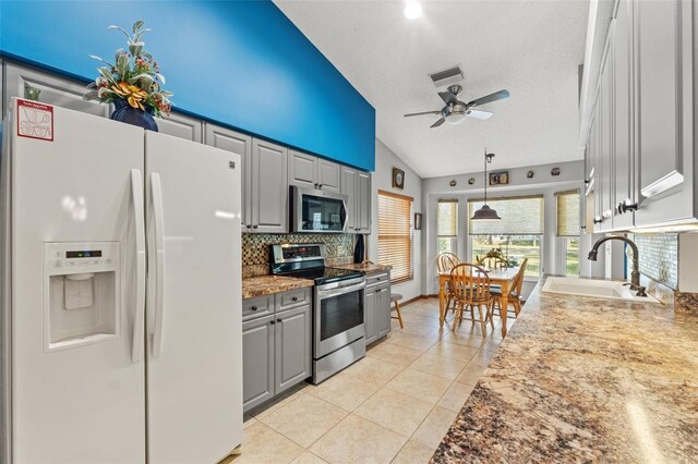 kitchen featuring appliances with stainless steel finishes, sink, gray cabinetry, and a textured ceiling