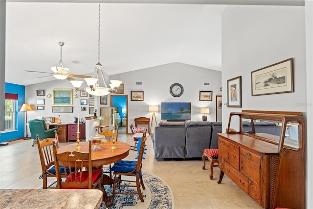 dining space featuring light tile patterned flooring, an inviting chandelier, and vaulted ceiling