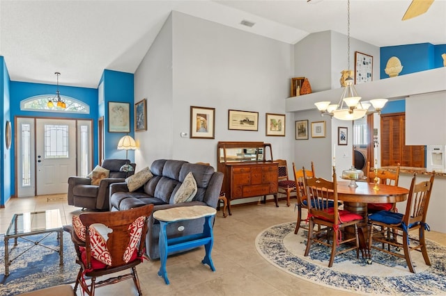 tiled dining room with high vaulted ceiling and an inviting chandelier