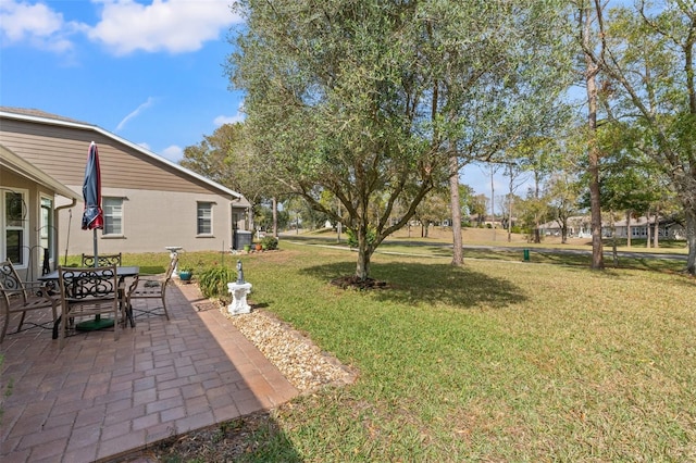 view of yard with a patio and central air condition unit