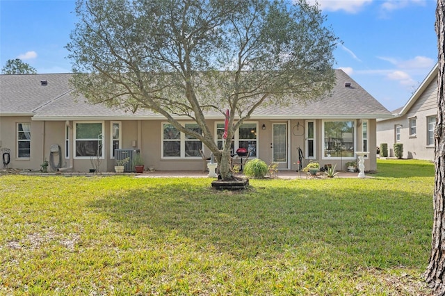 rear view of property featuring a yard