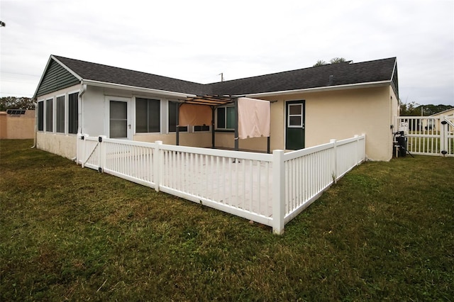 rear view of property featuring a yard