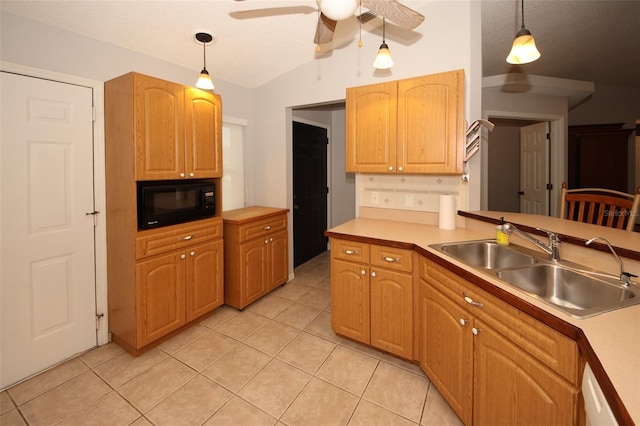 kitchen with light tile patterned flooring, lofted ceiling, sink, pendant lighting, and ceiling fan