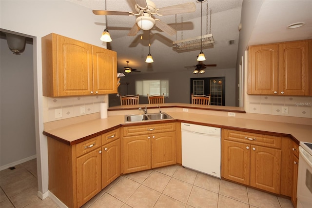 kitchen with light tile patterned flooring, sink, decorative light fixtures, dishwasher, and ceiling fan