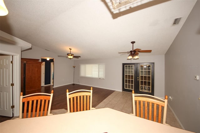 dining area with french doors, ceiling fan, vaulted ceiling, and tile patterned flooring