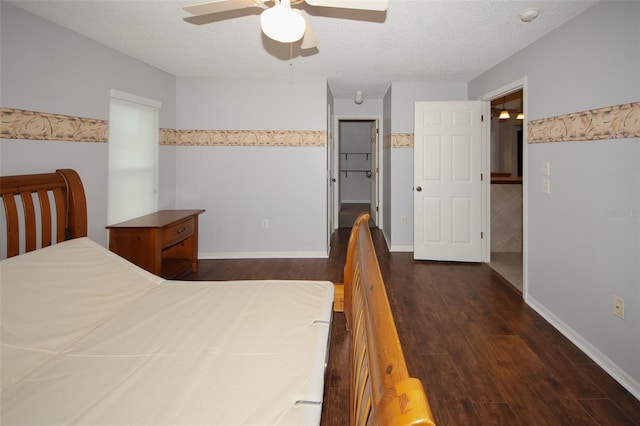 bedroom featuring dark hardwood / wood-style floors, a textured ceiling, and ceiling fan