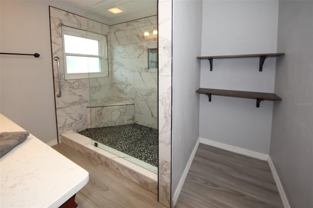 bathroom featuring hardwood / wood-style flooring and tiled shower