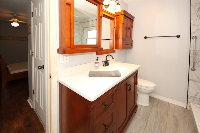 bathroom featuring vanity, wood-type flooring, walk in shower, and toilet