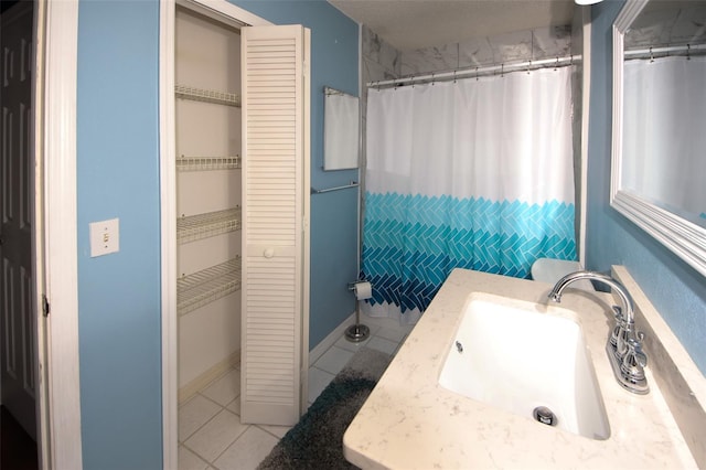 bathroom with tile patterned flooring, vanity, and curtained shower