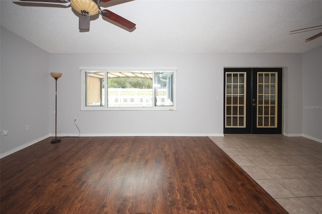 tiled spare room with french doors, ceiling fan, and a textured ceiling