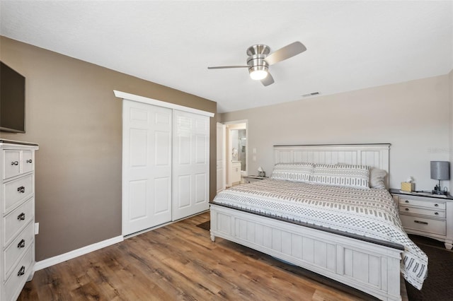 bedroom with ceiling fan, wood-type flooring, and a closet