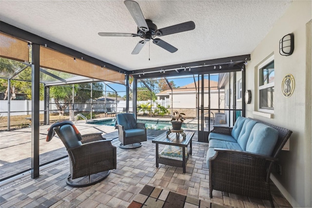 sunroom / solarium featuring ceiling fan