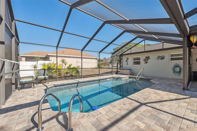 view of swimming pool featuring a lanai and a patio area