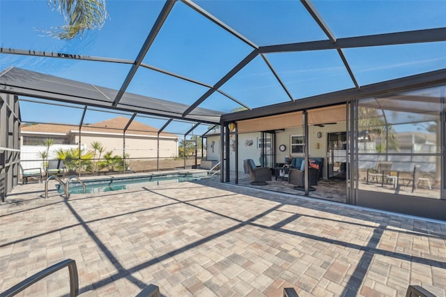 view of patio / terrace with a lanai, outdoor lounge area, and ceiling fan