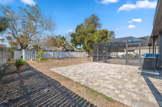 view of patio / terrace with central AC unit and a lanai