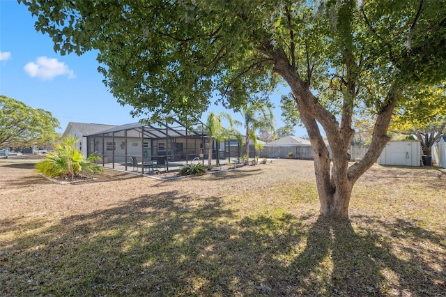 view of yard featuring a shed and a lanai