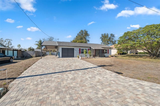 single story home featuring a carport and a garage