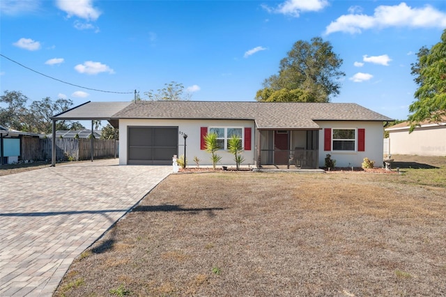 ranch-style home with a garage and a front lawn