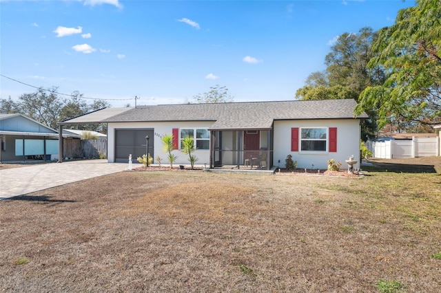 ranch-style home with a garage, a front lawn, and a sunroom