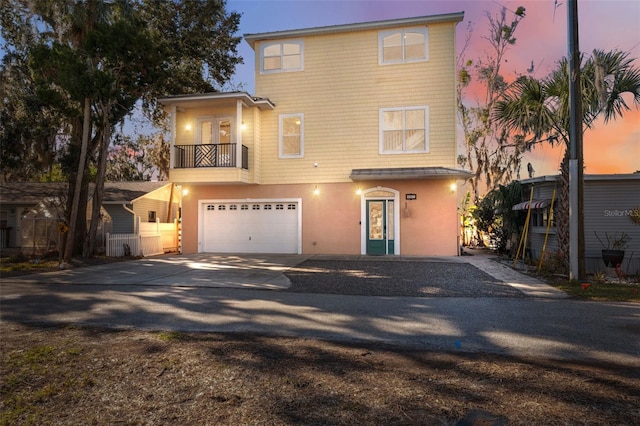 view of front facade with a garage and a balcony