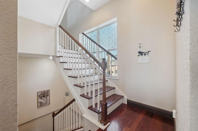 stairs featuring wood-type flooring