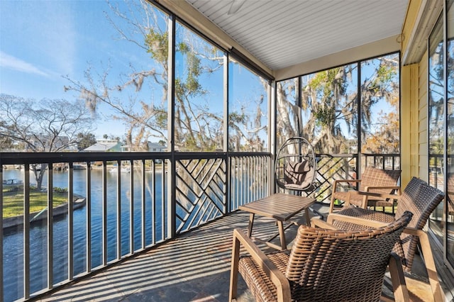 sunroom / solarium featuring a water view