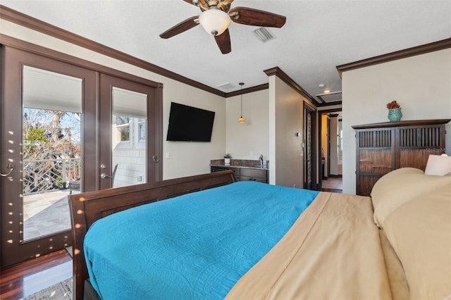 bedroom featuring french doors, sink, crown molding, hardwood / wood-style flooring, and access to exterior