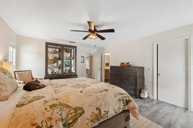 bedroom with wood-type flooring and ceiling fan